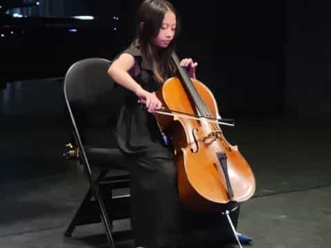 a person playing a cello