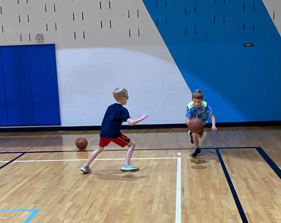 a couple of kids playing basketball