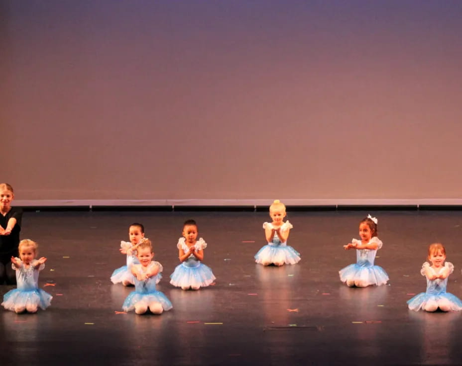 a group of dolls on a stage