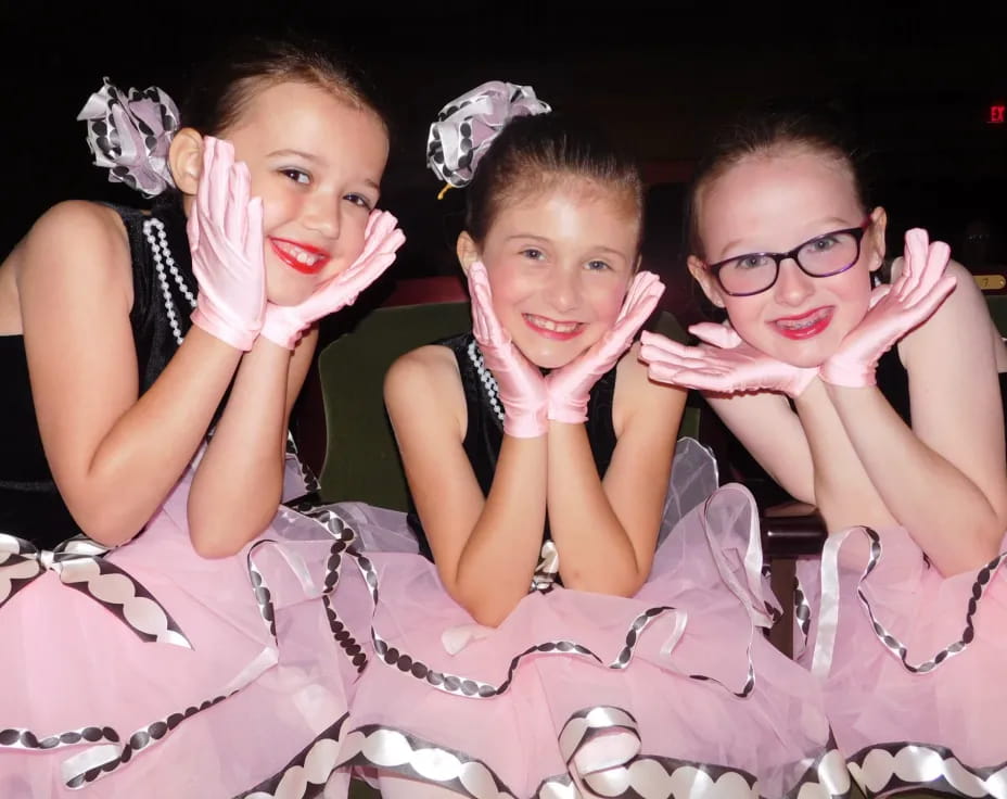 a group of girls in dresses