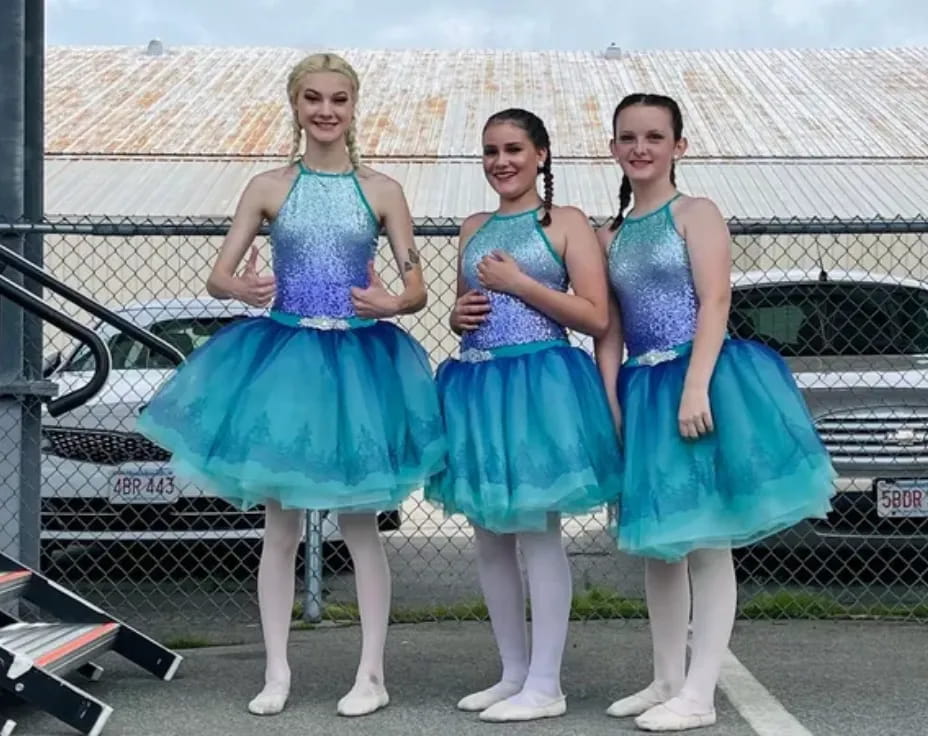 a group of women in blue dresses