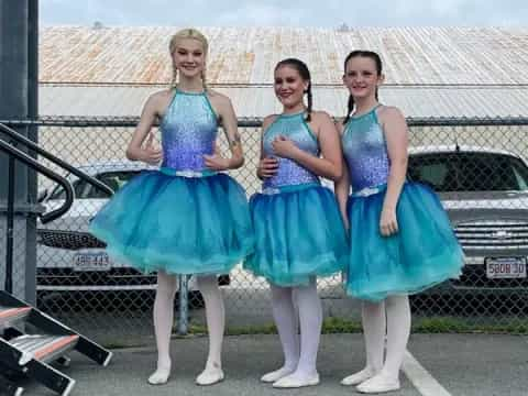 a group of women in blue dresses