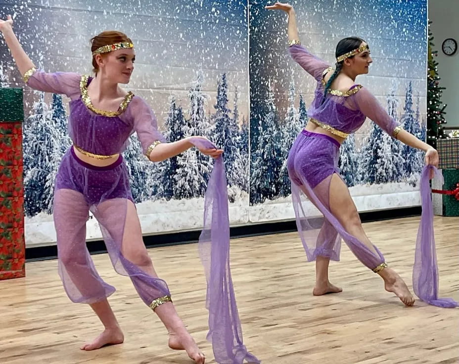 two women dancing on a stage