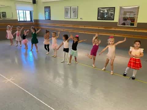 a group of children dancing in a room