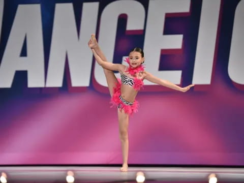 a woman in a red dress dancing on a stage