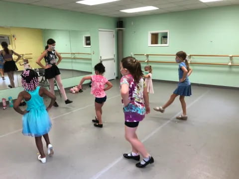 a group of girls dancing in a room