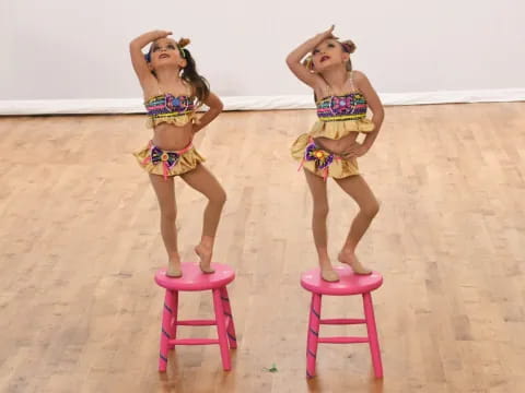 two girls in garments on stools