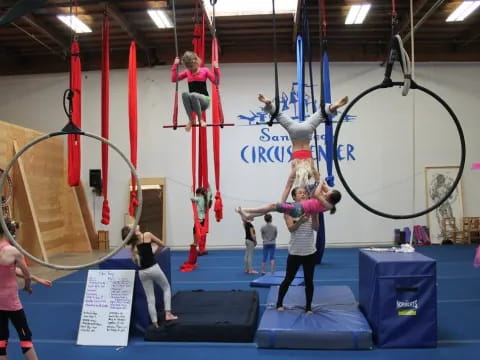 a group of people on a balance beam