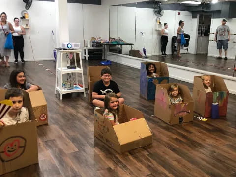a group of people in a room with boxes