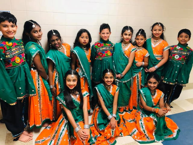 a group of women in colorful dresses