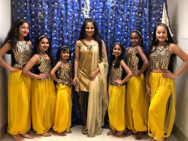 a group of women in yellow dresses