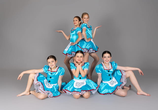 a group of women in blue dresses