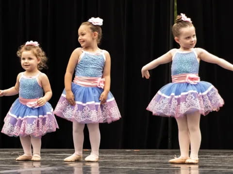 a group of girls in dresses