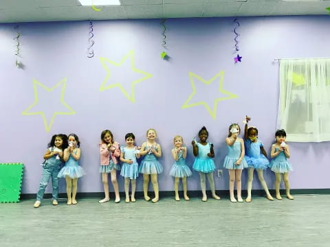 a group of girls in blue dresses