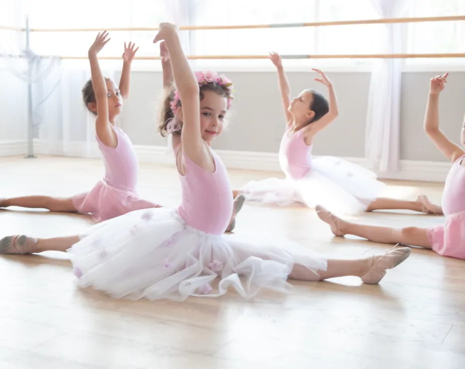 a group of girls in dresses dancing