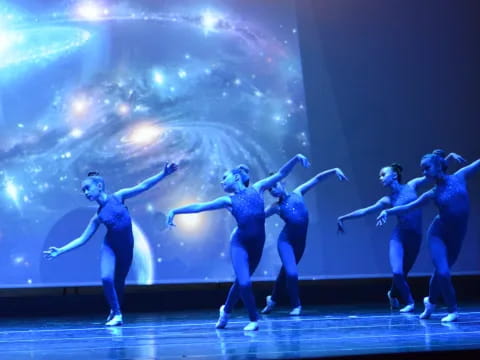 a group of people dancing on a stage