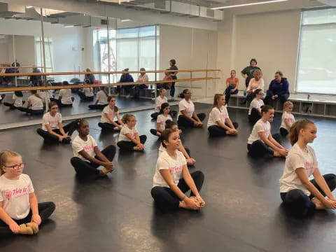 a group of people sitting on the floor in a room