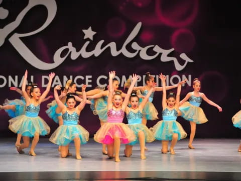 a group of girls dancing on a stage