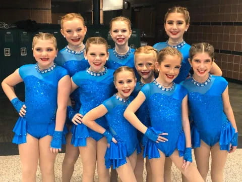 a group of girls in blue uniforms