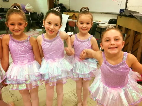 a group of girls in dresses