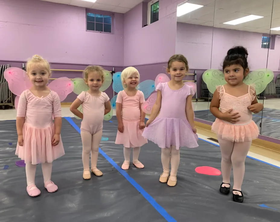 a group of girls in dresses