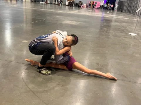 two people wrestling on the floor