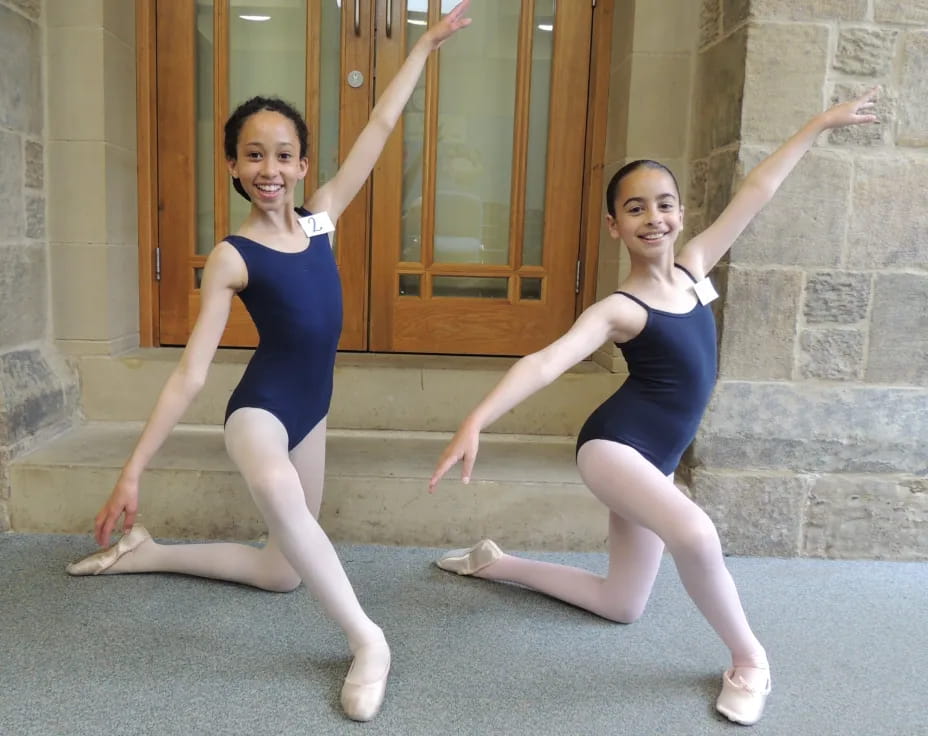 two women in blue leotards