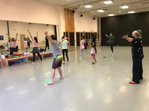 a group of people exercising in a room