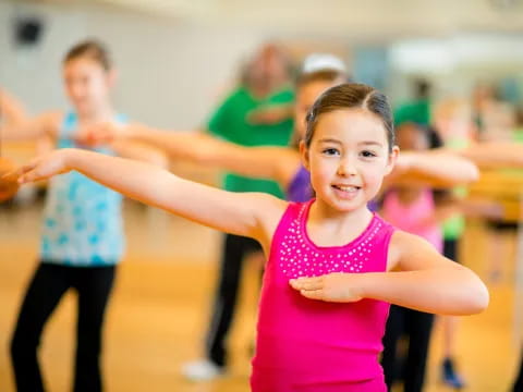 a young girl with her arms out