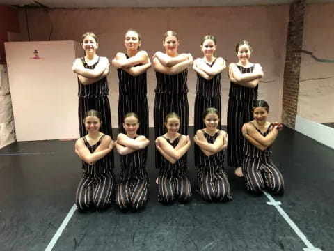 a group of women in black dresses