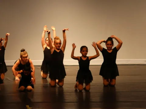 a group of girls in black dresses