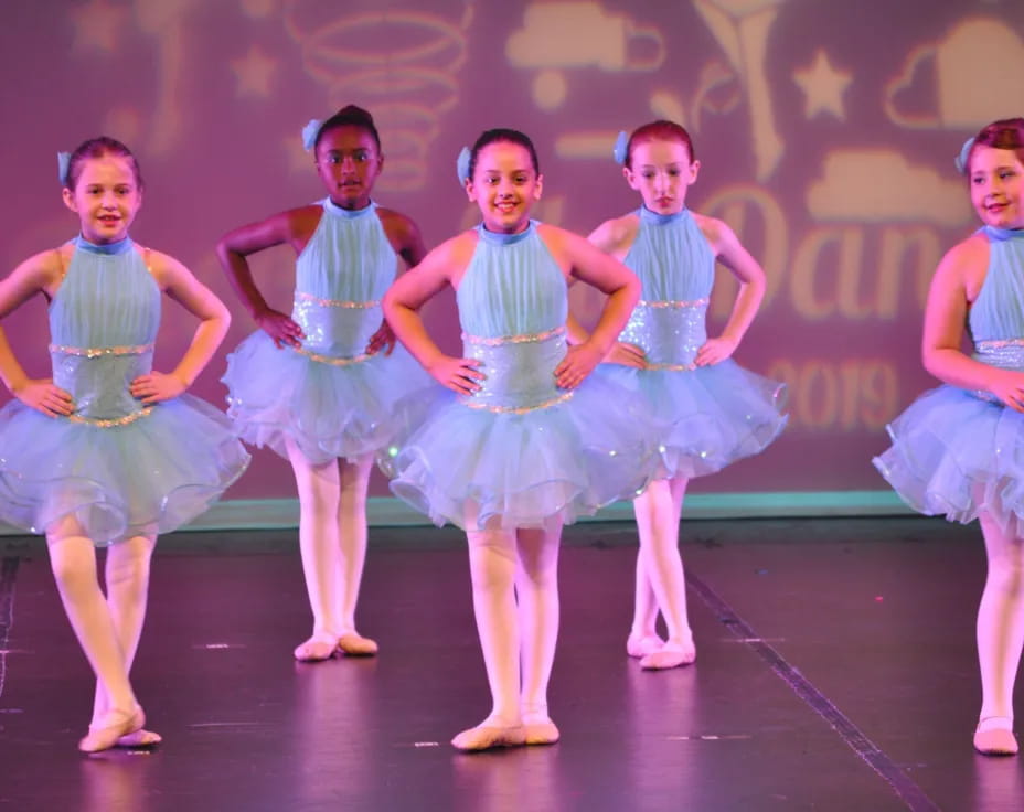 a group of girls in blue dresses