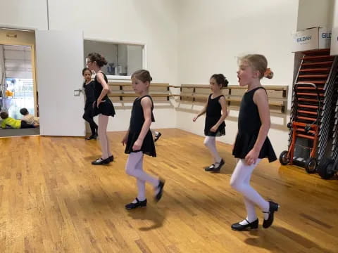 a group of girls dancing in a room