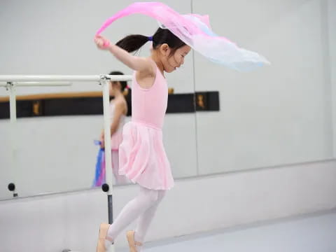 a woman in a pink dress holding a pink umbrella