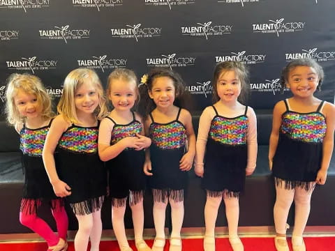 a group of girls in matching outfits