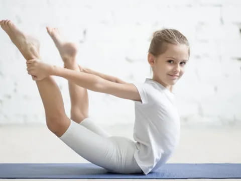 a young boy doing yoga