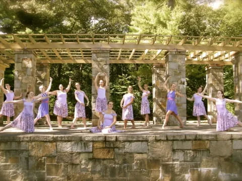 a group of girls in dresses posing for a photo