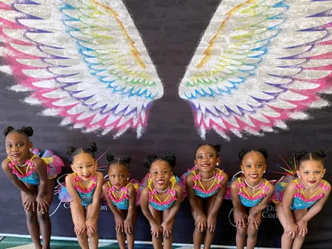 a group of girls in swimsuits posing for a photo