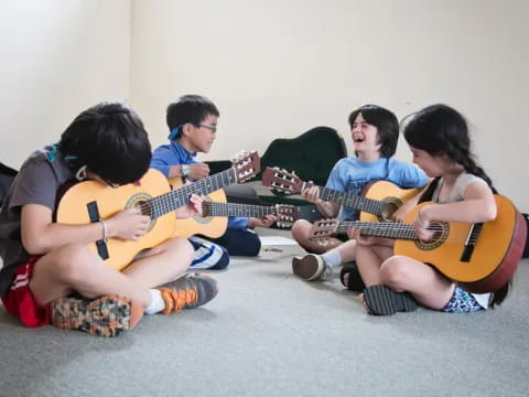 a group of people playing guitars