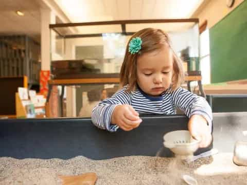 a girl sitting at a table