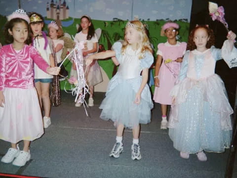 a group of girls in dresses