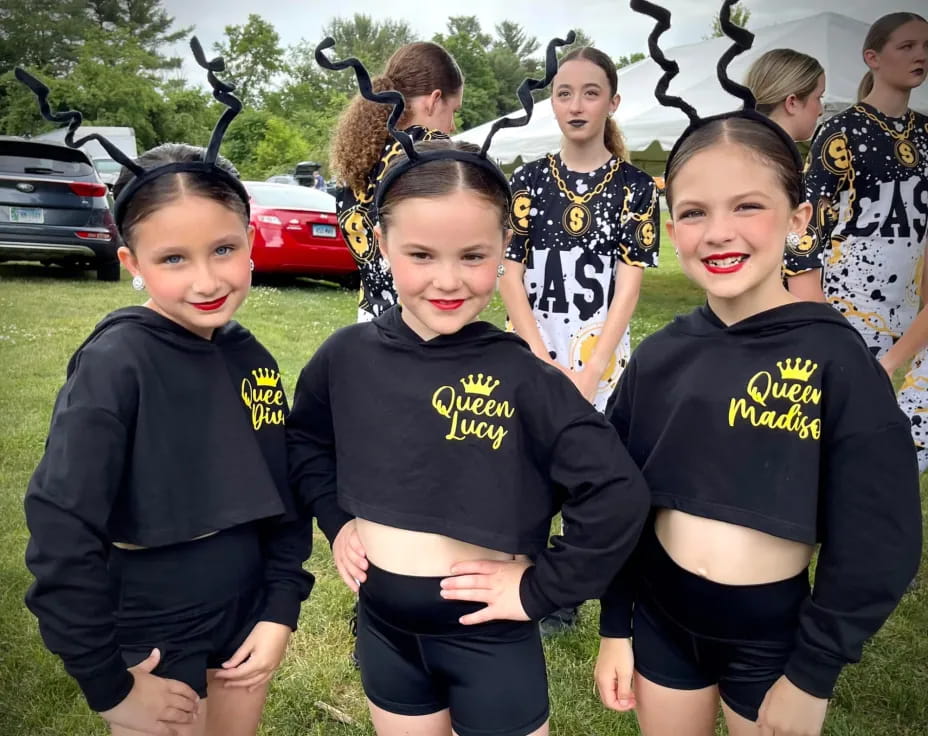 a group of girls in black shirts