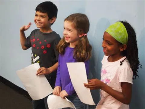 a group of children holding papers