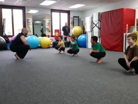 a group of people sitting on the floor with balloons