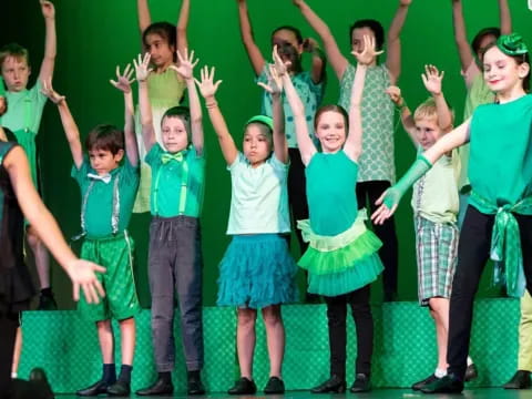 a group of children in green and blue uniforms