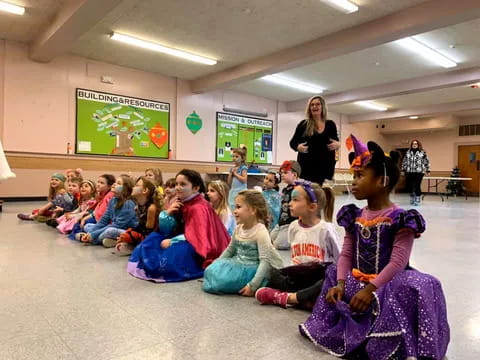 a group of children sitting in a classroom