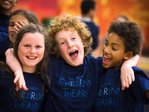 a group of children in blue shirts