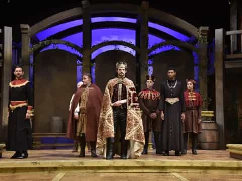a group of people in robes standing on a stage