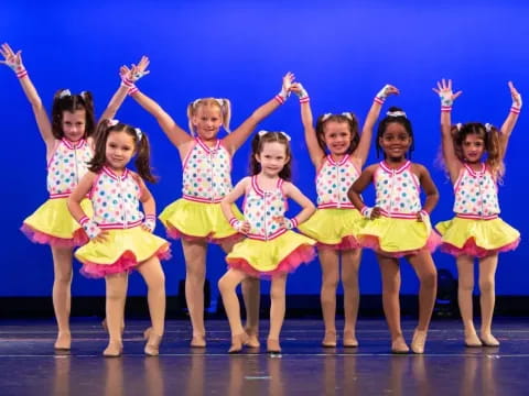 a group of girls in colorful skirts