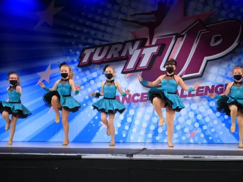 a group of women dancing on a stage